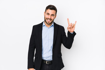 Young caucasian business man against a white background isolated showing a horns gesture as a revolution concept.