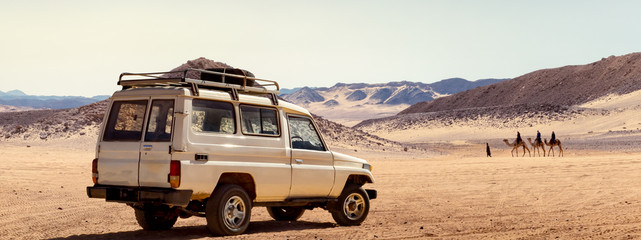 Travelling by car in a stone desert of Egypt or safari on a SUV automobile. - 319508127