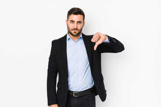 Young caucasian business man against a white background isolated showing a dislike gesture, thumbs down. Disagreement concept.