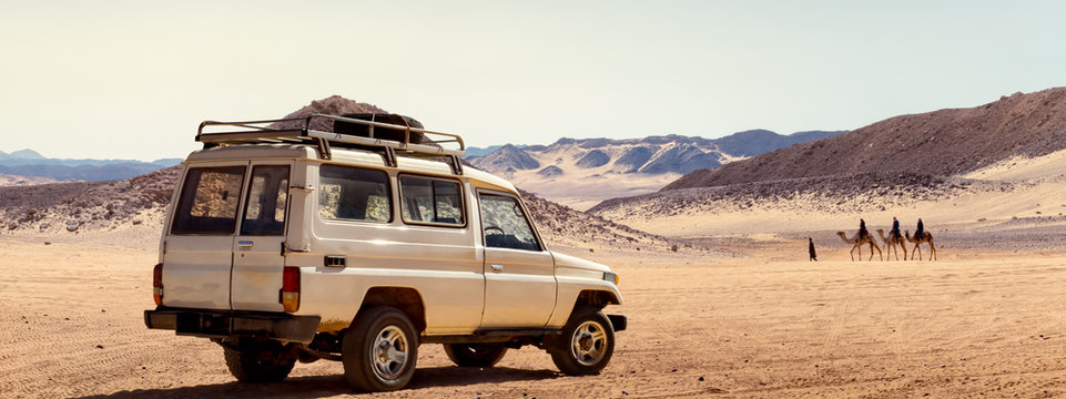 Travelling by car in a stone desert of Egypt or safari on a SUV automobile.