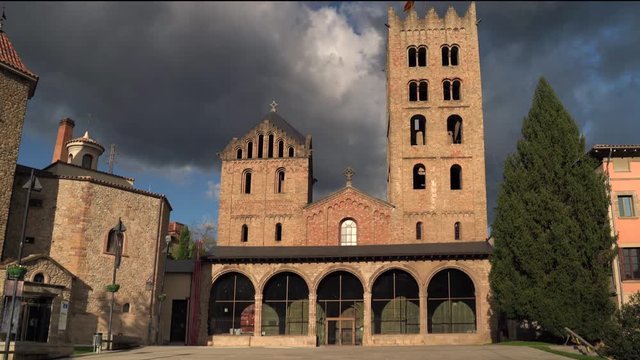 Medieval romanesque monastery of Ripoll in a sunny day with dramatic black clouds