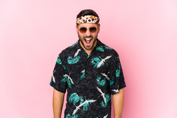 Young hipster man isolated screaming very angry and aggressive.