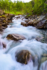 Blurry motions water of river. .River along the Aurlandsfjellet mountains in Norway.