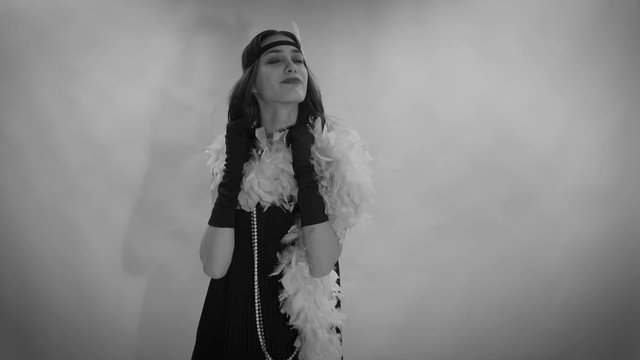 Footage video of Roaring twenties Gatsby,  flapper party girl, vintage 20's fashion style and make up and hairstyle, costume, model young woman, Caucasian girl