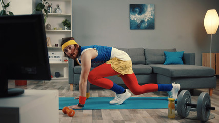 LOS ANGELES, CALIFORNIA, 10 OCTOBER, 2019: Handsome concentrated sportsman in retro outfit training...