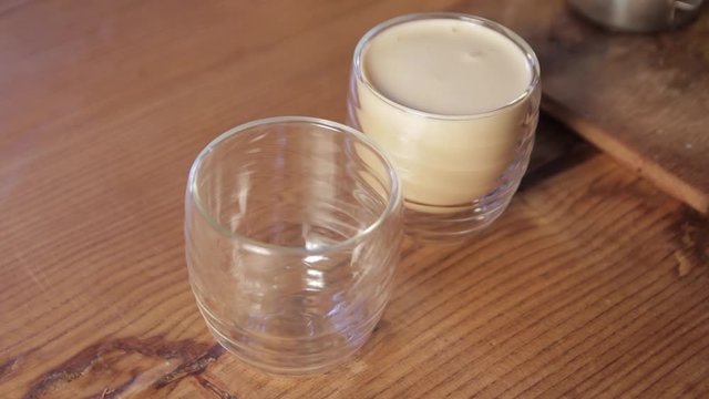 Pouring steamed milk into a cup.