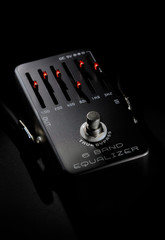 Close up view black color guitar pedal equalizer digital device for tone modifying