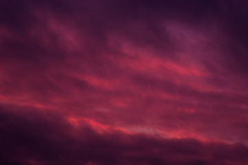Full frame view heavy moody sky cloudscape bright pink violet colors