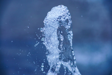 Photography of water white colored. Fresh jets of water fly up. Spray is flying in all directions...