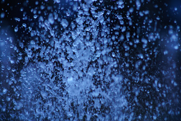Fototapeta na wymiar Water drops macro photography. Background is dark and blurry.