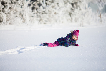 Fototapeta na wymiar Little cute toddler girl outdoors on a sunny winter day.