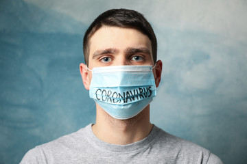 Boy in protective mask with inscription Coronavirus on blue background. Healthcare and medical...