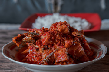 Balado fried fish, Padang cuisine and rice on wooden table