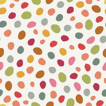 Colorful irregular grunge polca dots vector seamless pattern. Girly seamless pattern. Pink, yellow, orange, green circles on cream background. Vector illustration. Surface pattern design.