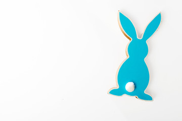 Blue wooden hare on a white background. Easter card.