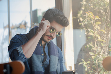 Fototapeta premium Young handsome and glasses man sitting