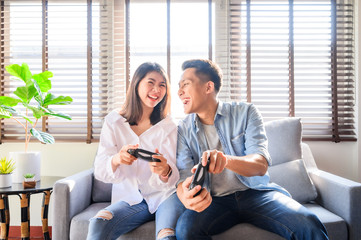 Couple having a good time playing video game together