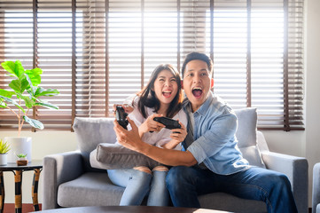 Couple having a good time playing video game together