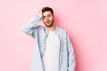 Young caucasian business man posing in a white background isolated tired and very sleepy keeping hand on head.< mixto >