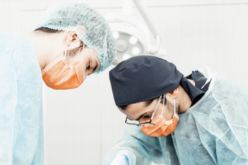 Dentists will perform an operation, implant placement. Real operation. Tooth extraction, implants. Professional uniform and equipment of a dentist. Healthcare Equipping a doctor’s workplace. Dentistry