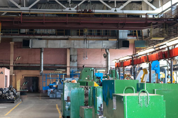 A large industrial workshop inside the building with machine tools and a warehouse with tools for repair and manufacture of spare parts and equipment at the factory
