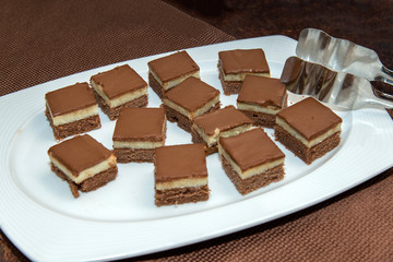 chocolate pastries in a white plate over a dark surface