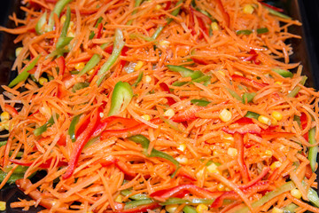 closeup of a salad made of carrots, peppers and corn