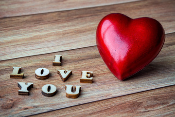 Red heart and text I Love You on wooden background. Valentine's day, mother's day, birthday, celebration concept