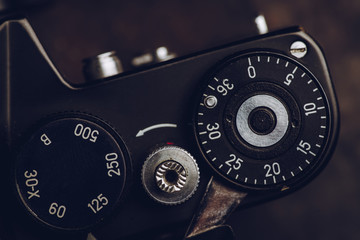 Vintage camera on the dark rustic background. Selective focus. Shallow depth of field.