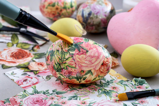 Decorating Easter eggs with decoupage technique.