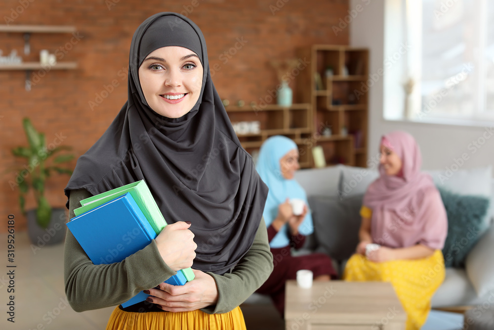 Wall mural female muslim student at home