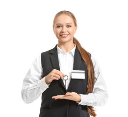 Portrait of female hotel receptionist with room key on white background