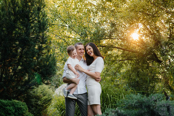 Happy family with their son walking in the Park at sunset. Happiness. Love