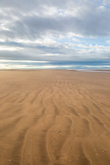 Fototapeta na wymiar Ripples in the sand, on Formby Beach in Merseyside