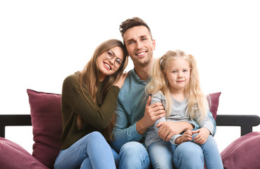 Happy young family sitting on sofa against white background