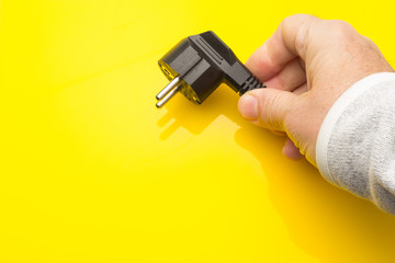 Black plug on colored background