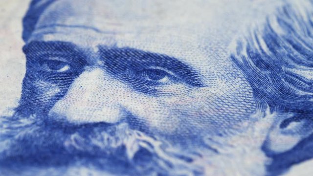 Giuseppe Verdi on Italy 1000 lira (1964) banknote rotating. Famous Italian composer. Macro shot. Low angle. 4K, 422 10 bit