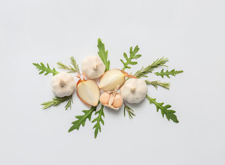 Fresh garlic and arugula on white background