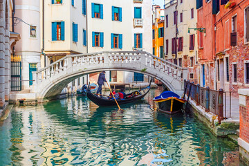 Fototapeta na wymiar Picturesque canal with a gondola, Venice, Italy