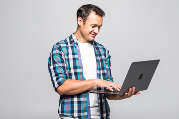 Happy young man with laptop isolated on white background