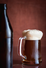 Black beer in a pint with foam. Dark beer mug.  Cold drink