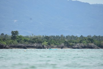 A Tropical Coastline Ocean And Mountains