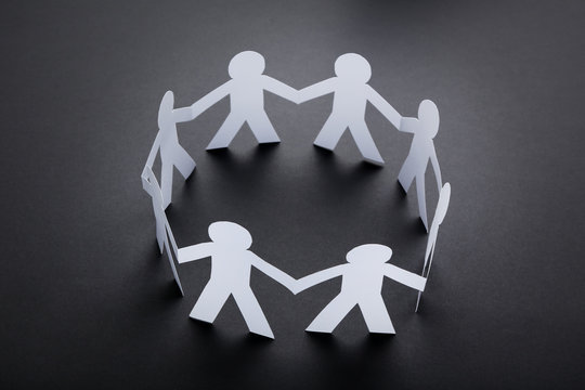 Paper chain people on black background