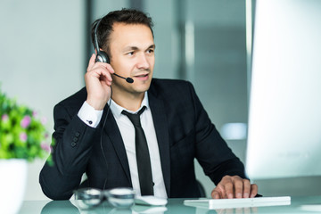 Businessman talking on the pc with headset in the office