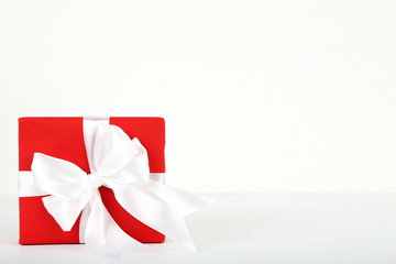 Red gift box with ribbon on white background
