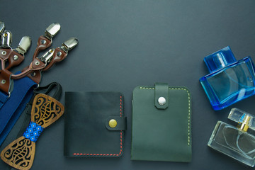Men's Accessories. Men's wallet, men's butterfly, suspenders and perfume on a dark background....
