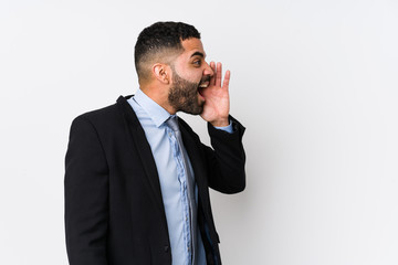 Young latin business woman against a white background isolated shouting and holding palm near opened mouth.