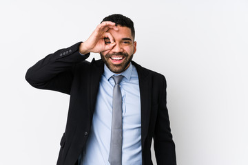 Young latin business woman against a white background isolated excited keeping ok gesture on eye.