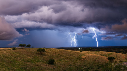 Naklejka na ściany i meble Thunderstorm with lightning strikes and dramatic storm clouds