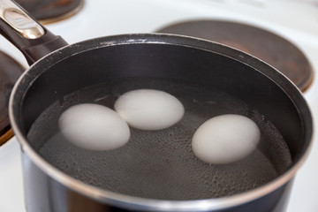 History of making a quick Breakfast. Chicken eggs are cooked in a pan on the stove. Moscow, Russia.